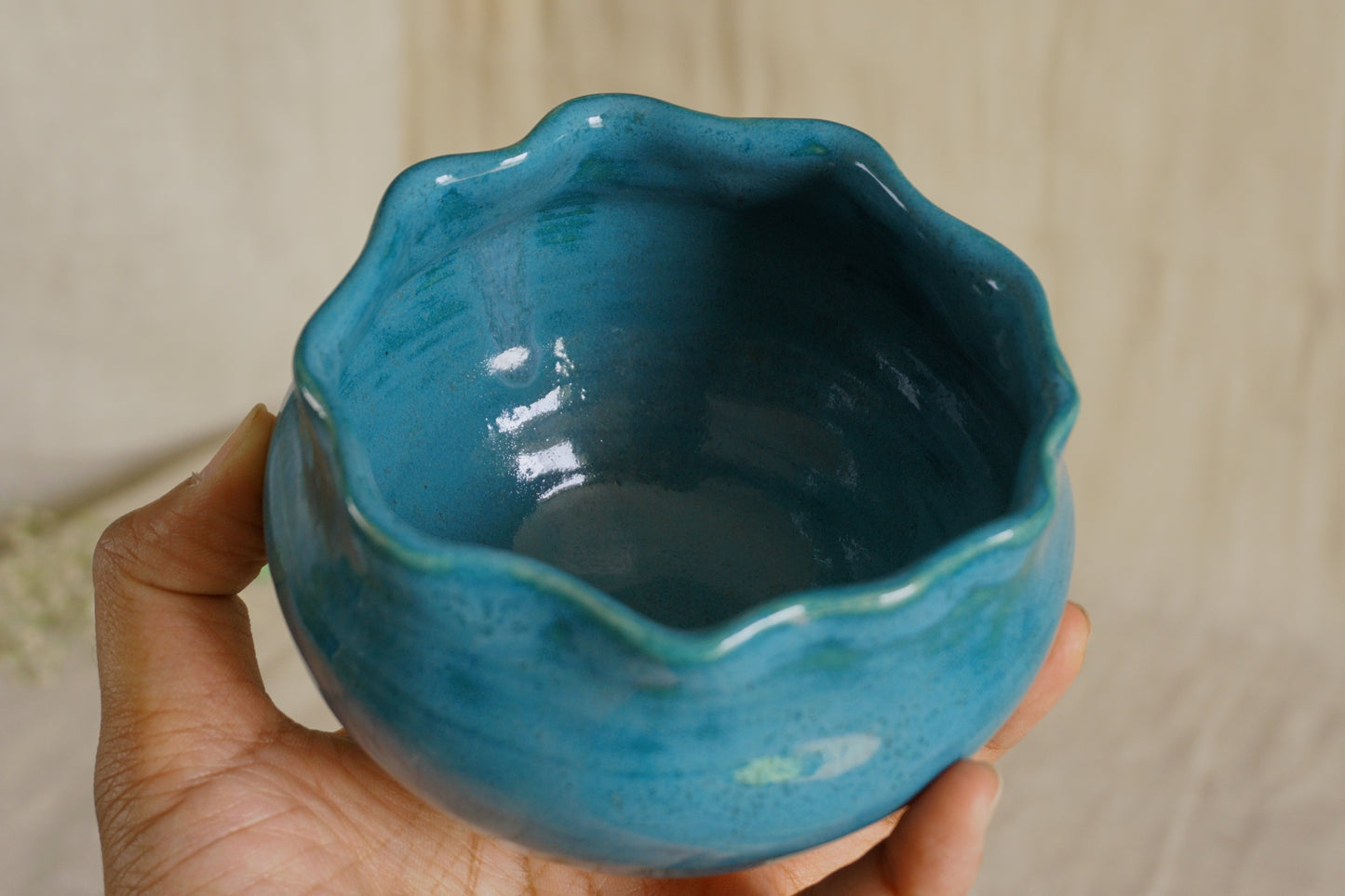 Teal blue bowl with a wavy rim
