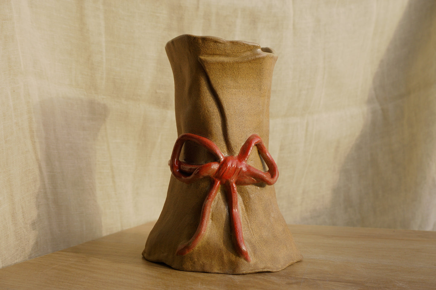 Brown paper vase with a ribbon bow