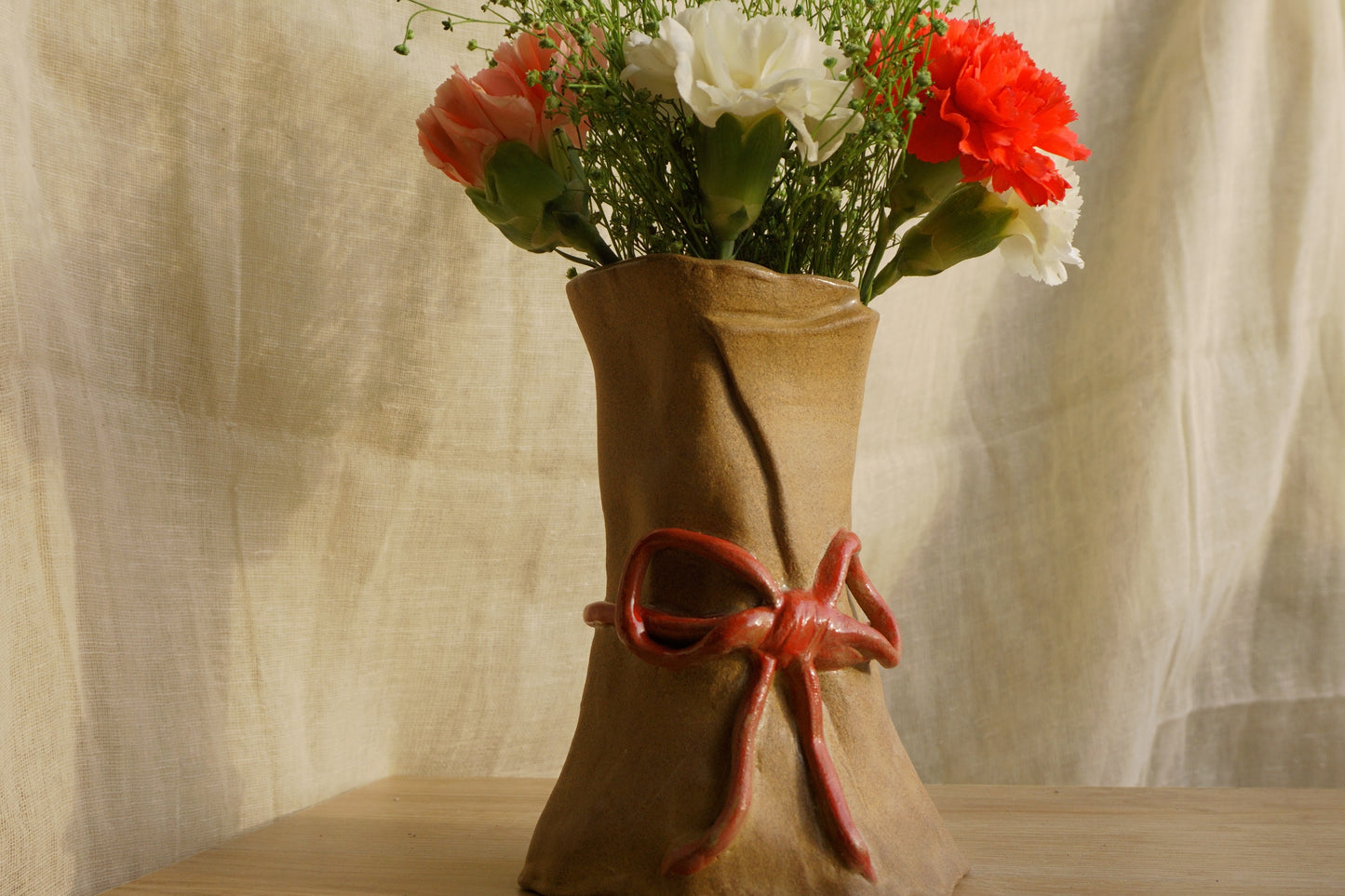 Brown paper vase with a ribbon bow