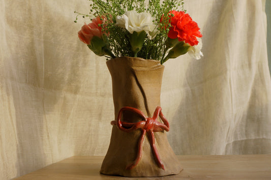 Brown paper vase with a ribbon bow