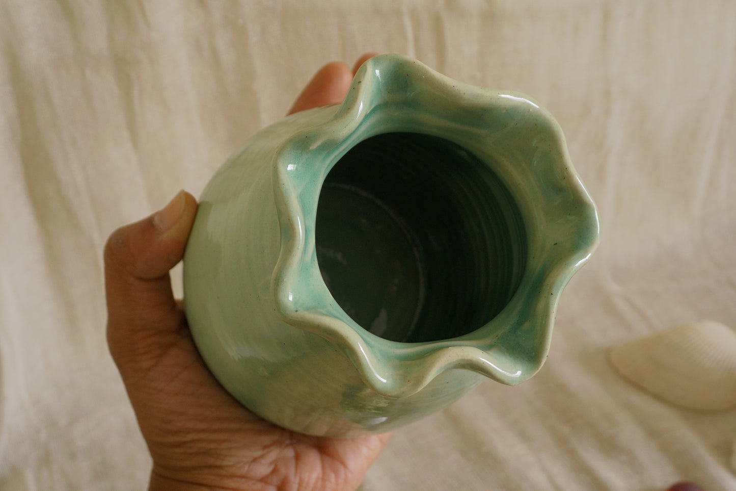 Celadon green vase with wavy rim