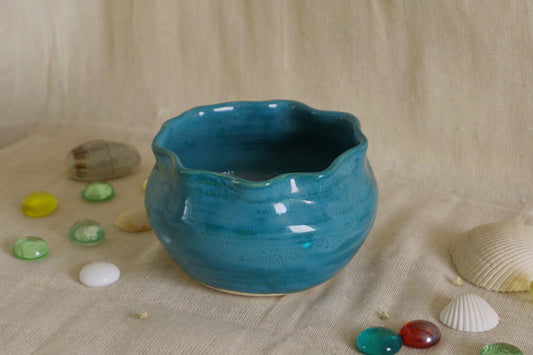 Teal blue bowl with a wavy rim