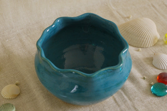 Teal blue bowl with a wavy rim