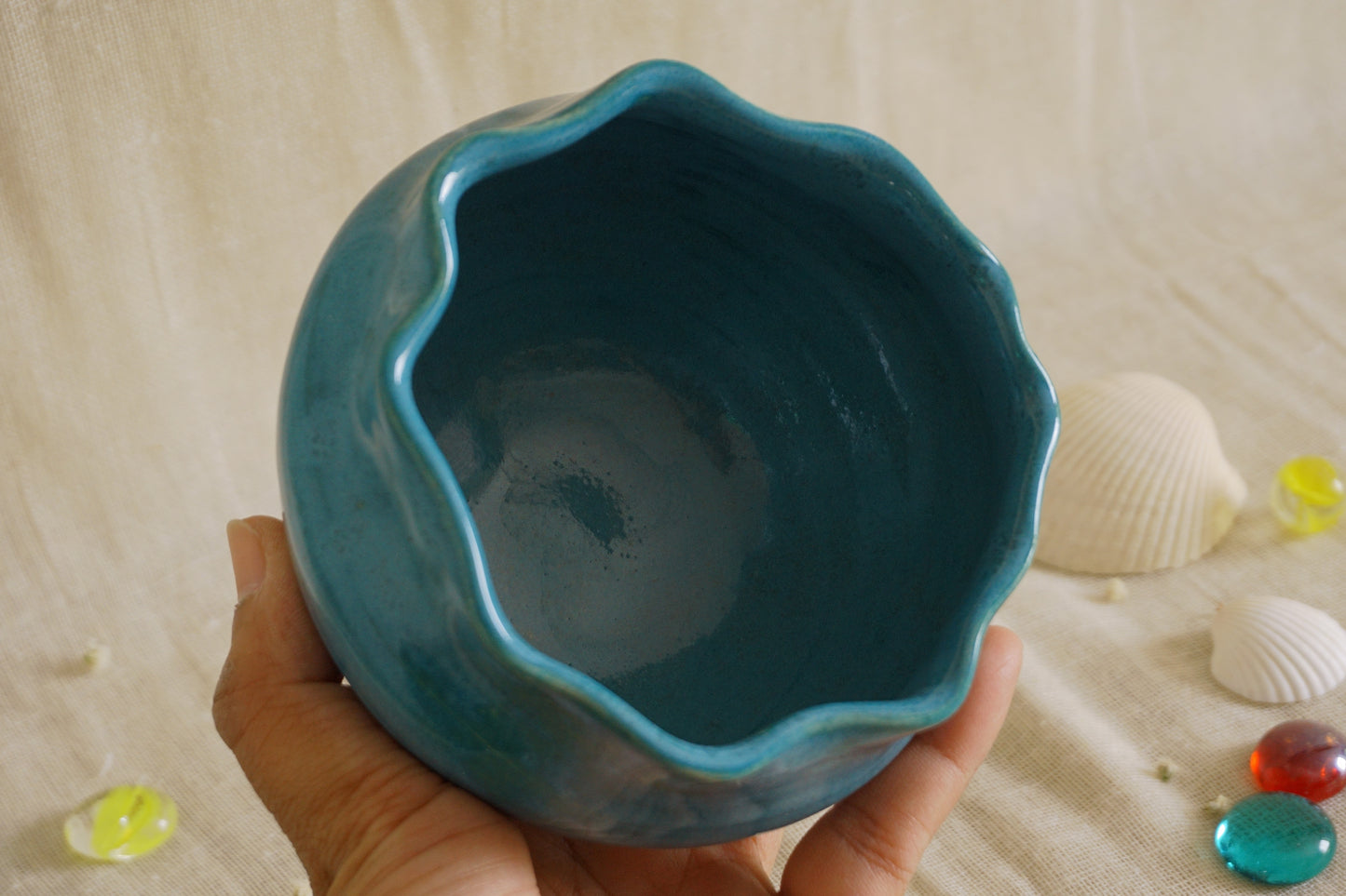 Teal blue bowl with a wavy rim