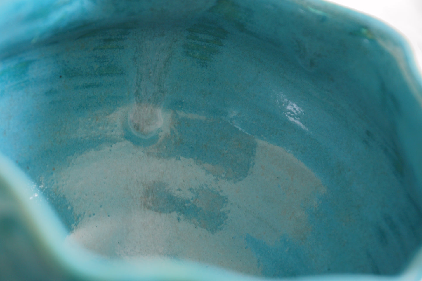 Teal blue bowl with a wavy rim