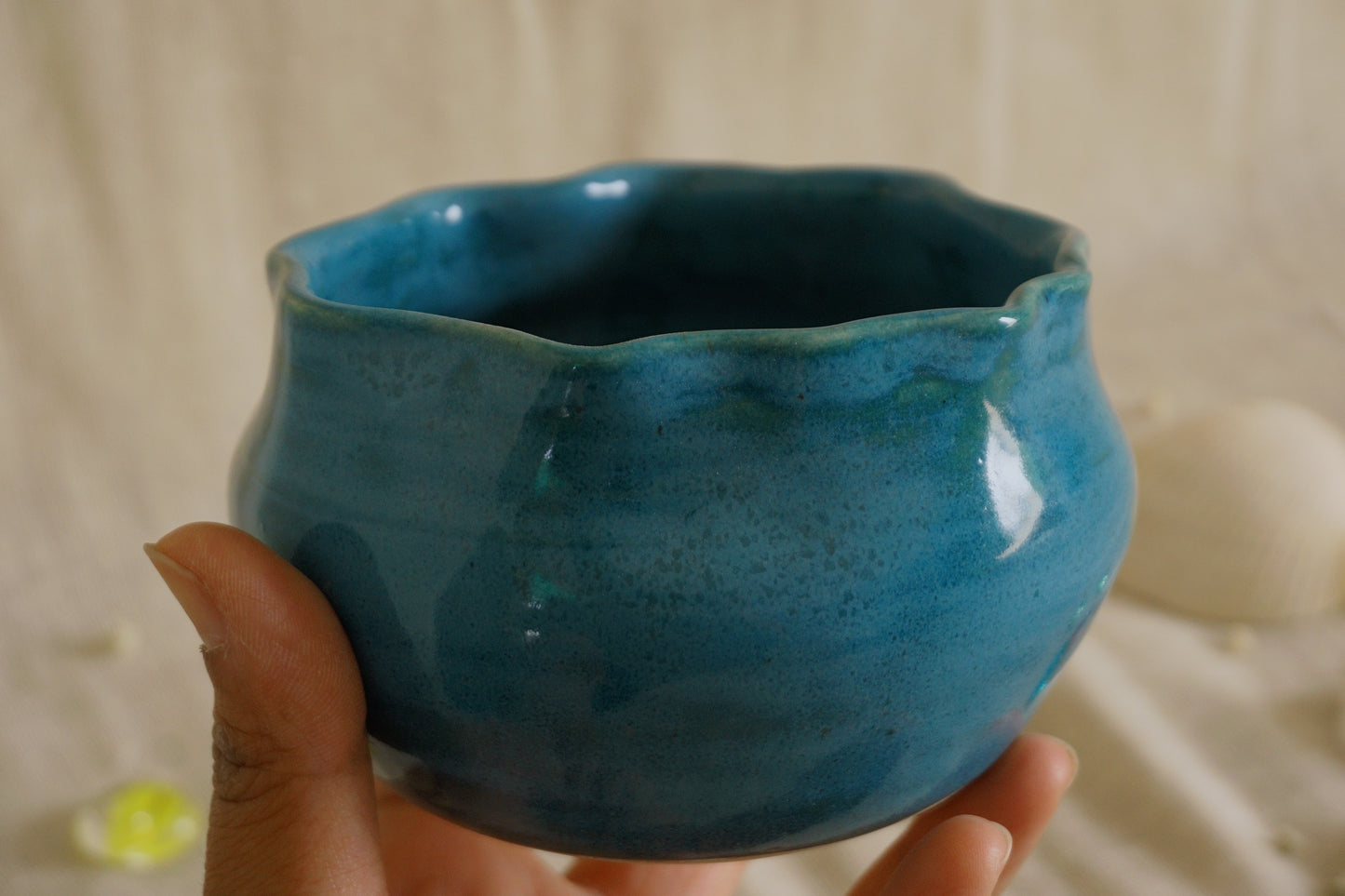 Teal blue bowl with a wavy rim