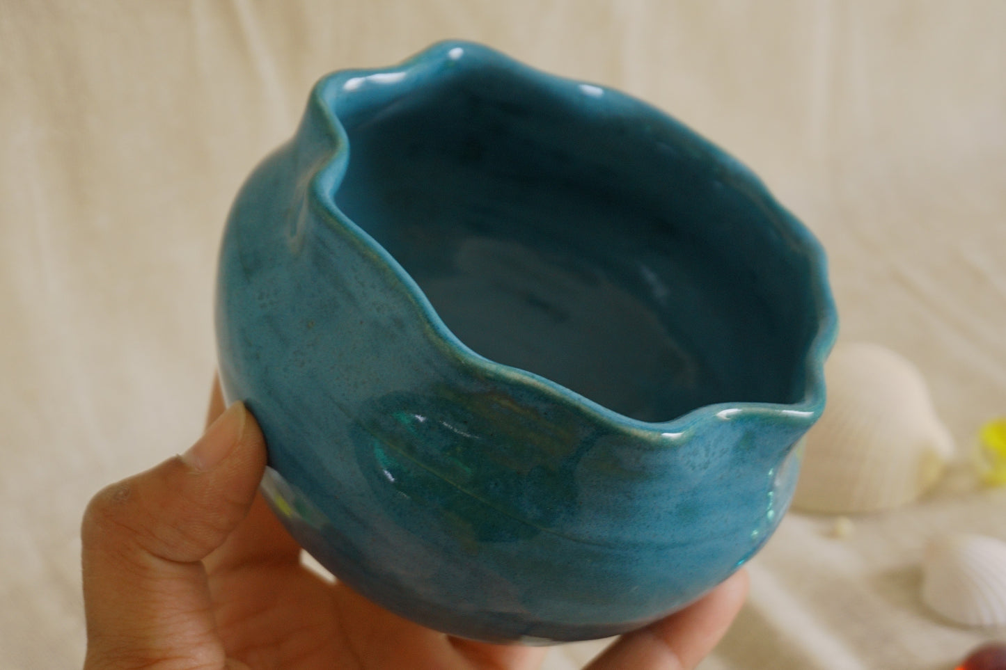 Teal blue bowl with a wavy rim