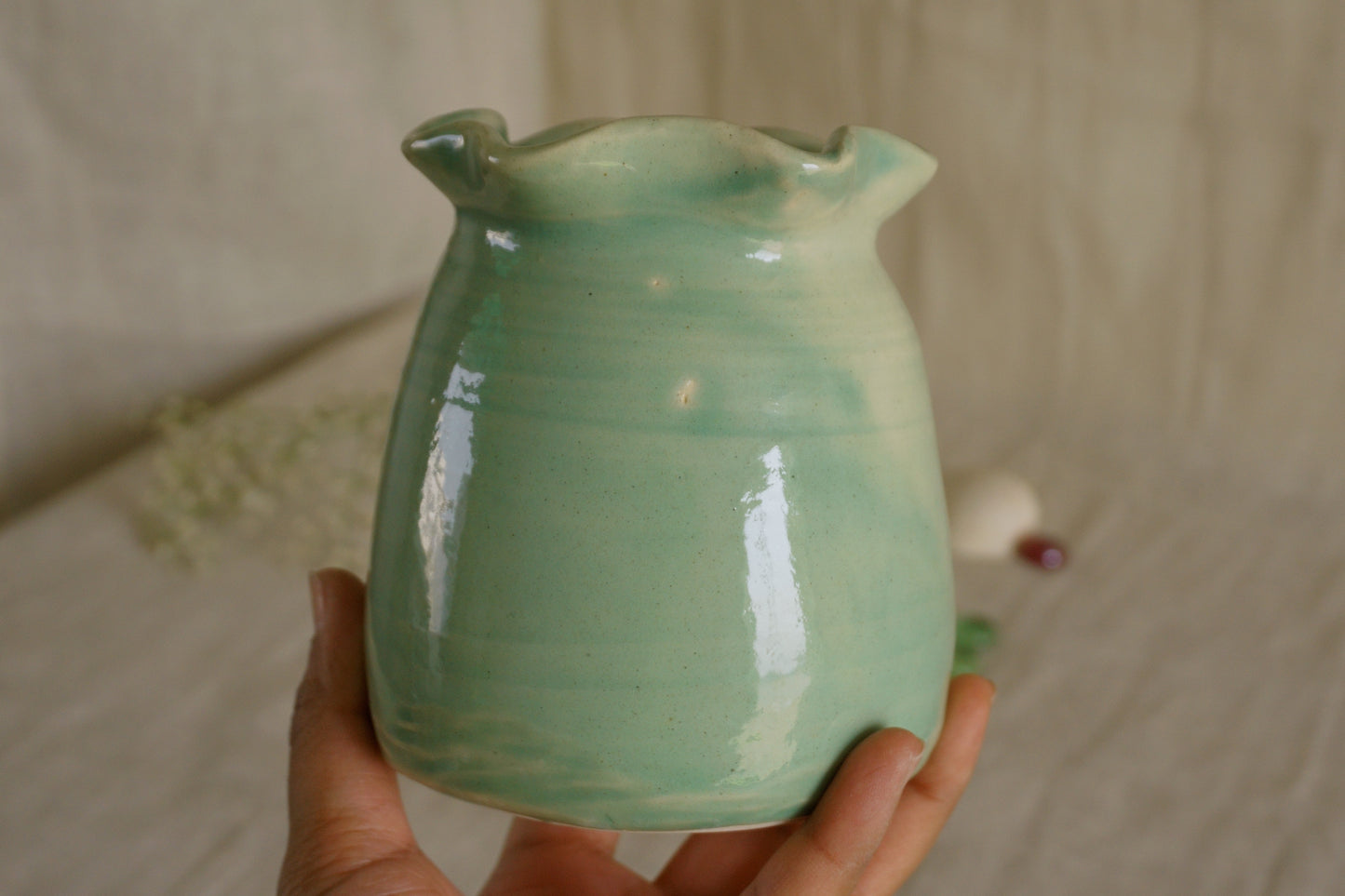 Celadon green vase with wavy rim