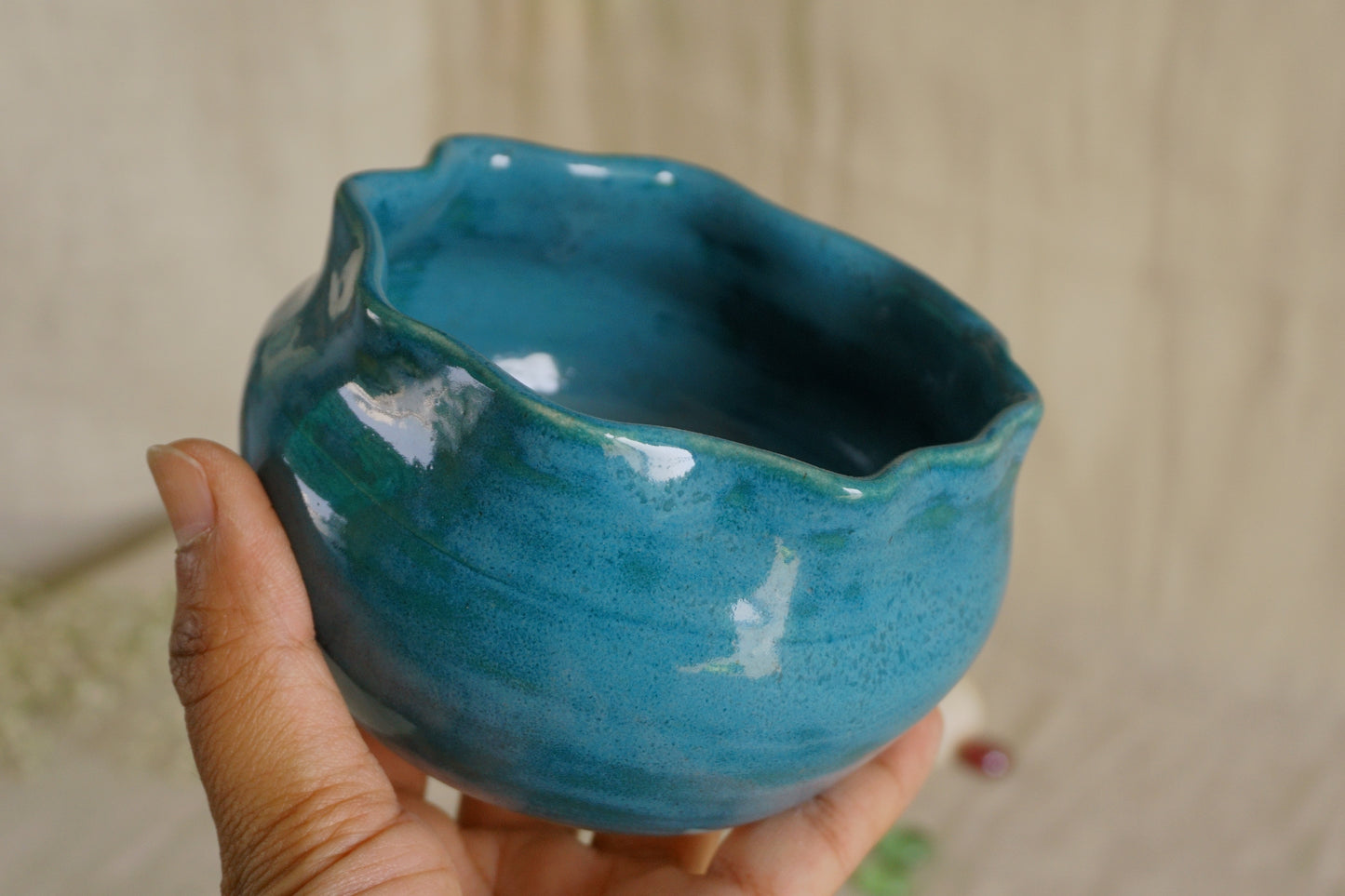 Teal blue bowl with a wavy rim