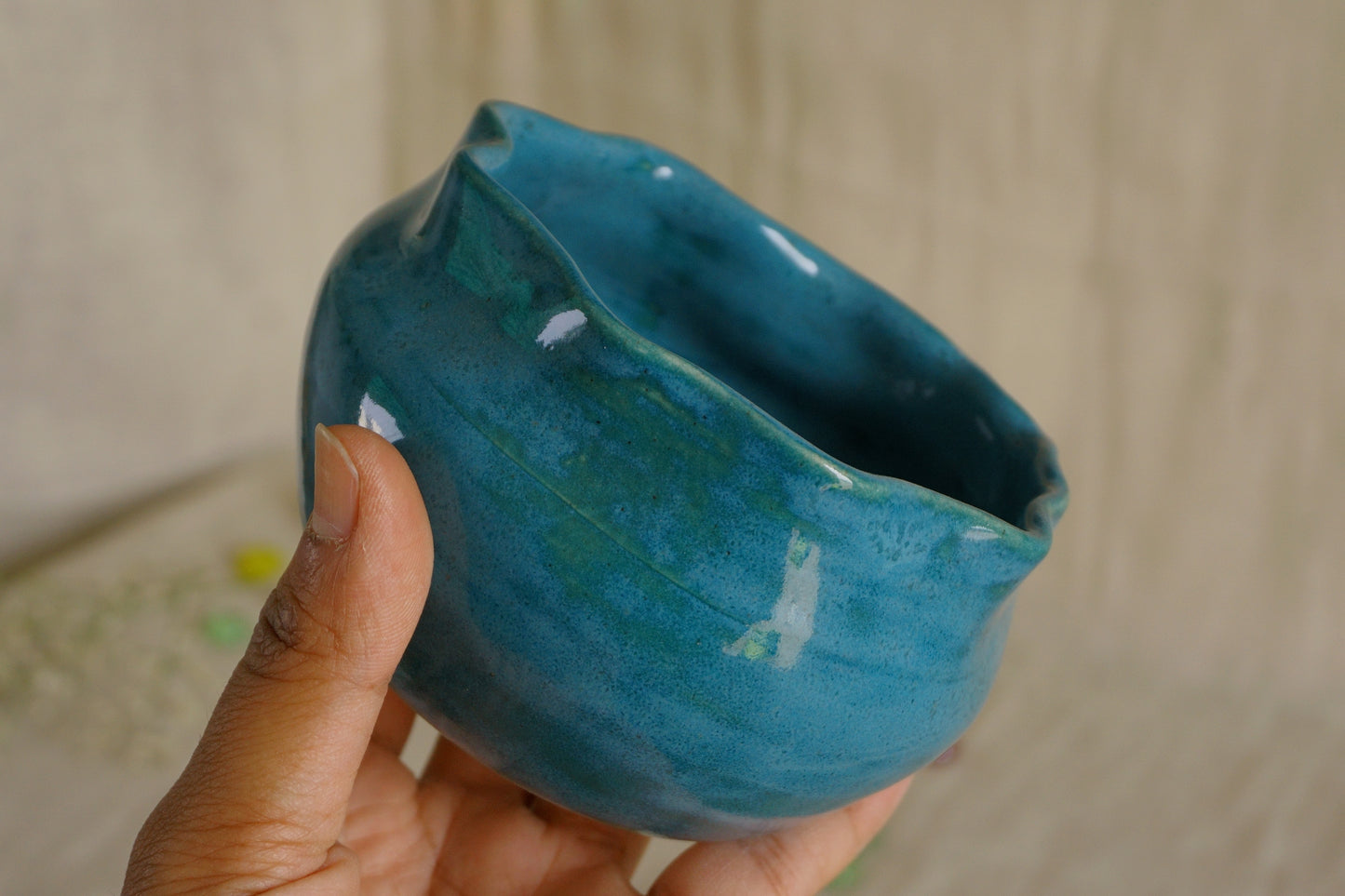 Teal blue bowl with a wavy rim